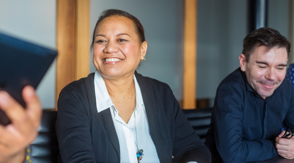 two people sitting together, smiling and enjoying a conversation