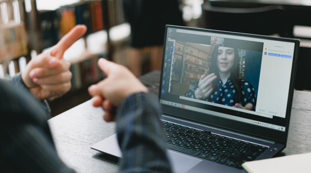 Man uses sign language to speak with a woman through video call